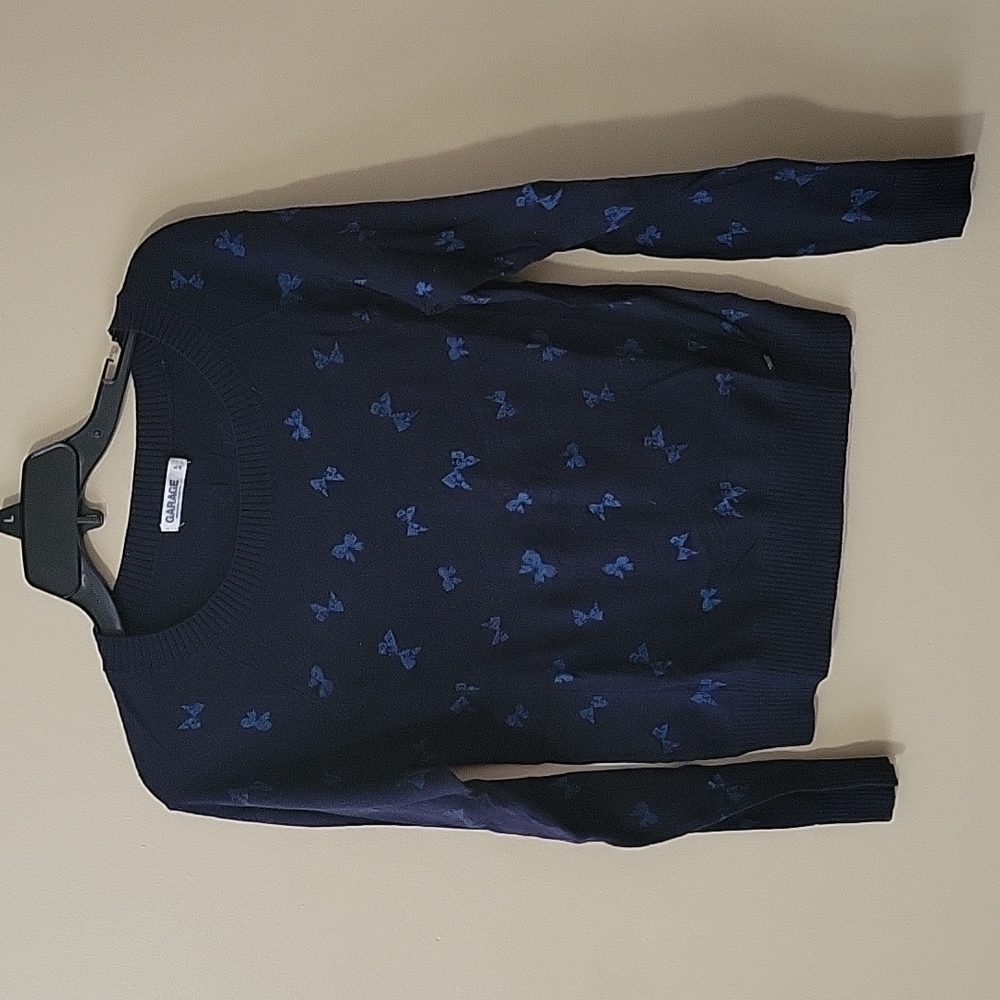 A small navy Garage sweater with light blue bows